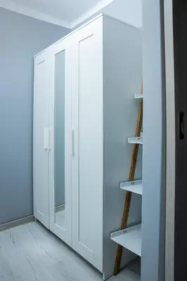 a white wardrobe with a mirror in a room at Lovely place-apartament Oświęcim in Oświęcim