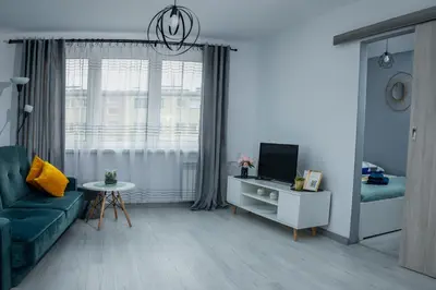 a living room with a couch and a tv at Lovely place-apartament Oświęcim in Oświęcim