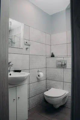 a white bathroom with a toilet and a sink at Lovely place-apartament Oświęcim in Oświęcim