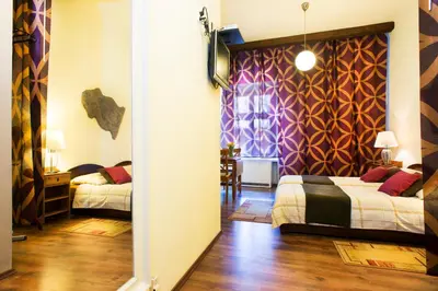 a room with two beds and a room with a hallway at Mikolajska Residence in Kraków