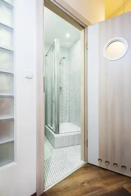 a bathroom with a shower and a glass door at Mikolajska Residence in Kraków