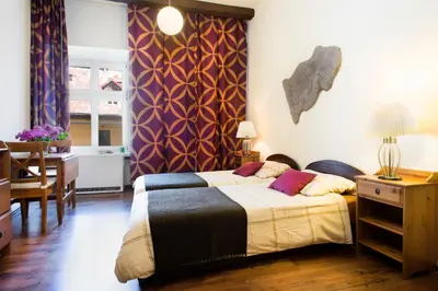 a bedroom with a bed and a table and a dining room at Mikolajska Residence in Kraków