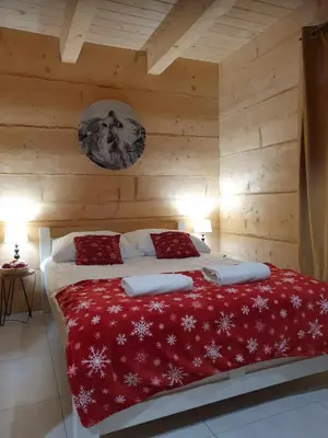 a bedroom with a bed with a red blanket at Willa Białego Wilka w Zawoi in Zawoja