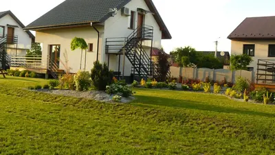 a house with a yard with green grass at Zator Lider House Energy in Zator