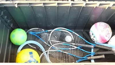 a group of tennis rackets and balls on a shelf at Zator Lider House Energy in Zator