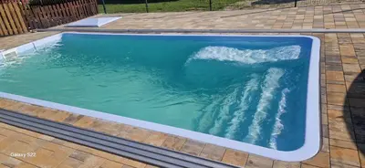 a swimming pool with a wave in the water at Zator Lider House Energy in Zator