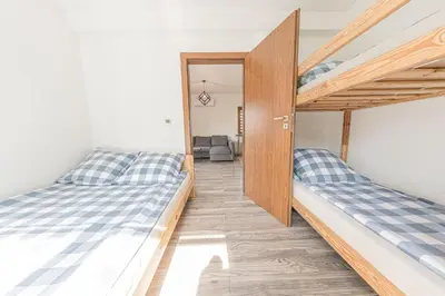 a bedroom with two bunk beds and a doorway at Zator Lider House Energy in Zator