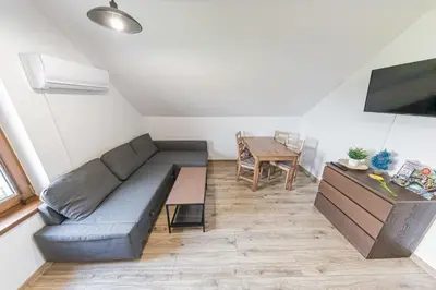 a living room with a couch and a table at Zator Lider House Energy in Zator