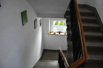 a staircase with a window in a house at Travel Apartament Cracow in Kraków