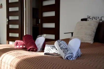 a bed with towels and pillows on top of it at Travel Apartament Cracow in Kraków