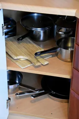 a cabinet filled with pots and pans and utensils at Travel Apartament Cracow in Kraków