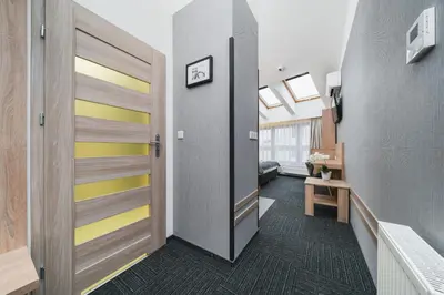 a hallway with a sliding door in a room at Aron Residence - by Upstairs in Kraków