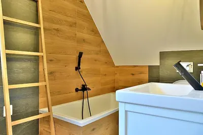 a bathroom with a sink and a bath tub at Wyspa Zdarzeń - klimatyczny dom w sercu natury! in Żmiąca