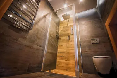 a bathroom with a shower stall and a toilet at Na Skraju Raju in Zator