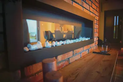 a living room with a brick fireplace at Na Skraju Raju in Zator