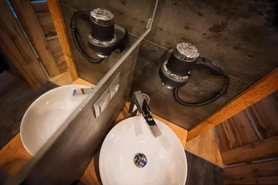 a bathroom with a toilet and a sink with two speakers at Na Skraju Raju in Zator