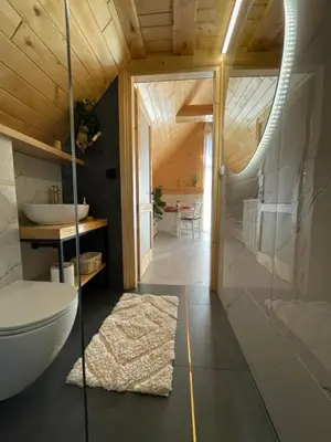 a bathroom with a tub and a toilet and a sink at The View House Rabka-Zdrój WELLNESS & SPA in Rabka