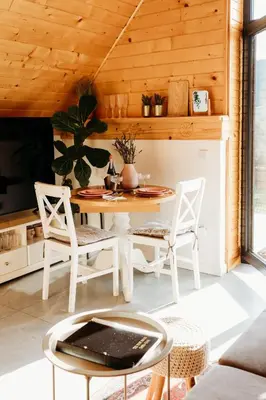 a living room with a table and chairs at The View House Rabka-Zdrój WELLNESS & SPA in Rabka