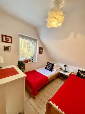 a bedroom with a large bed and a mirror at Klimatyczny dom z widokiem na Babią - kominek i ogrodzenie in Maków Podhalański