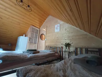 a room with two beds in a wooden cabin at U Krysi in Kojszówka