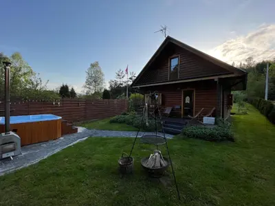 a small house with a pool in the yard at U Krysi in Kojszówka