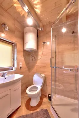 a bathroom with a toilet and a sink and a shower at U Krysi in Kojszówka
