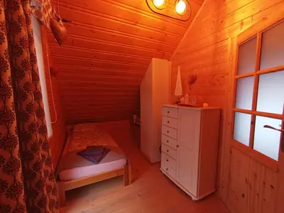 a small room with a cabinet and a chair in a cabin at U Krysi in Kojszówka