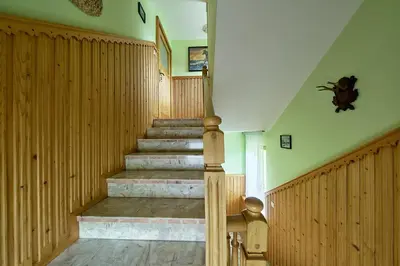 a staircase in a home with wooden paneling and stairs sidx sidx sidx at Noclegi Obidowa-Pod Grapą in Obidowa
