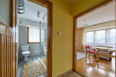 a bathroom with a toilet and a table at Noclegi Obidowa-Pod Grapą in Obidowa