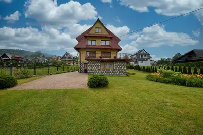 a house with a tower on top of a yard at Noclegi Obidowa-Pod Grapą in Obidowa