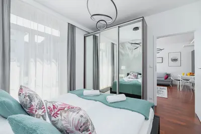 a bedroom with two beds and a mirror at Apartment Łobzowska Cracow by Noclegi Renters in Kraków