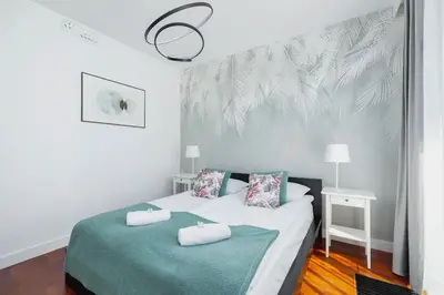 a bedroom with a bed with two towels on it at Apartment Łobzowska Cracow by Noclegi Renters in Kraków