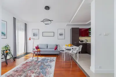 a living room with a couch and a table at Apartment Łobzowska Cracow by Noclegi Renters in Kraków
