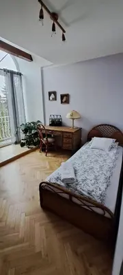 a bedroom with a bed and a desk in it at SOSNOWA 23 in Tenczynek