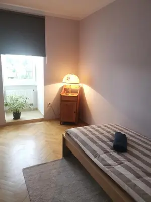 a bedroom with a bed and a lamp and a window at SOSNOWA 23 in Tenczynek