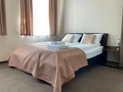 a bedroom with a bed with a blanket on it at DOMINGO Elegant Rooms KRAKÓW Old Town in Kraków