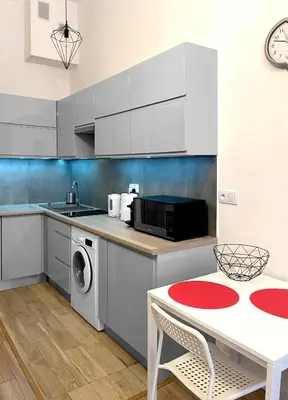a kitchen with a table and a microwave at Starowiślna 41-43 by PI Apartments in Kraków