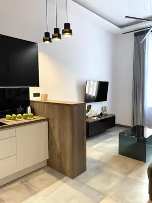 a kitchen with black and white cabinets and a counter at Starowiślna 41-43 by PI Apartments in Kraków