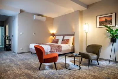 a hotel room with a bed and a chair at MR67 Mayera Rapaporta in Kraków