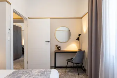 a bedroom with a desk and a mirror at MR67 Mayera Rapaporta in Kraków