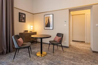 a room with a table and two chairs and a dresser at MR67 Mayera Rapaporta in Kraków