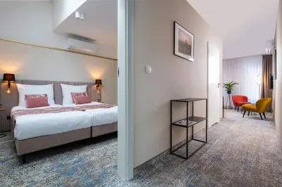 a hotel room with a bed and a hallway at MR67 Mayera Rapaporta in Kraków