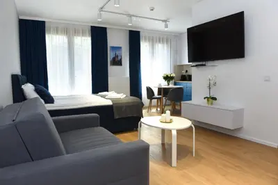 a living room with a bed and a couch at Pearl Apartments-Kossak Residence Apartamenty w centrum Krakowa in Kraków
