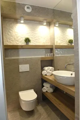 a bathroom with a white toilet and a sink at Pearl Apartments-Kossak Residence Apartamenty w centrum Krakowa in Kraków