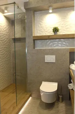 a bathroom with a toilet and a glass shower at Pearl Apartments-Kossak Residence Apartamenty w centrum Krakowa in Kraków