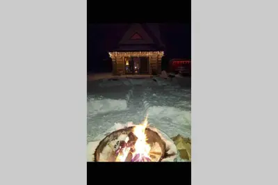 a fire pit in a swimming pool at night at Bystry domek w Beskidach przy szlaku na Babią Górę in Bystra