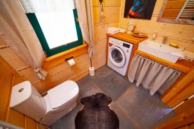 a dog laying on the floor in a bathroom at Bystry domek w Beskidach przy szlaku na Babią Górę in Bystra