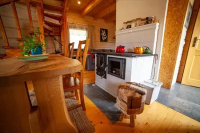 a kitchen with a stove and a table in a room at Bystry domek w Beskidach przy szlaku na Babią Górę in Bystra