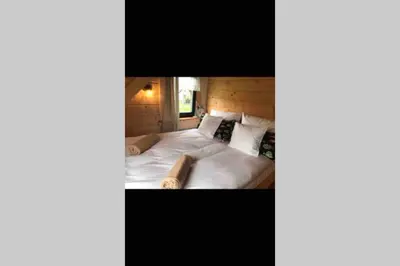 a bedroom with a large bed with white sheets and pillows at Bystry domek w Beskidach przy szlaku na Babią Górę in Bystra