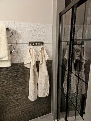 a bathroom with white towels hanging on a wall at Sara -Mikołajska - Rynek - Netflix Hydromassage in Kraków
